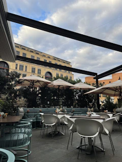 A peaceful café terrace overlooking a historic plaza, inviting moments of calm and refinement.