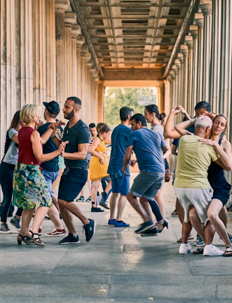 A bachata class in session with students smiling and moving in sync.