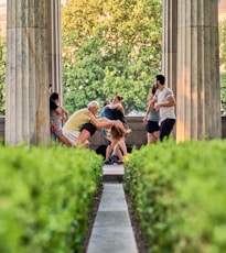 a group of people sitting on a bench