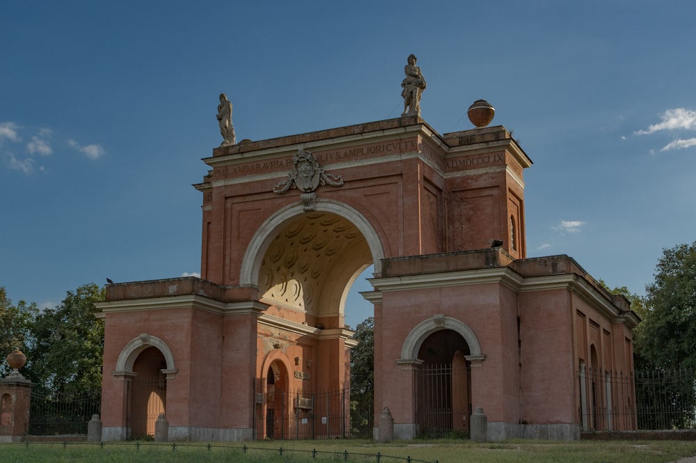 a large brick building with statues on top