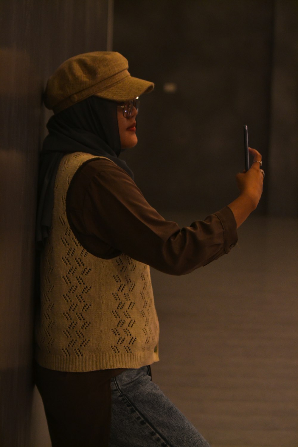 a man in a hat holding a cell phone