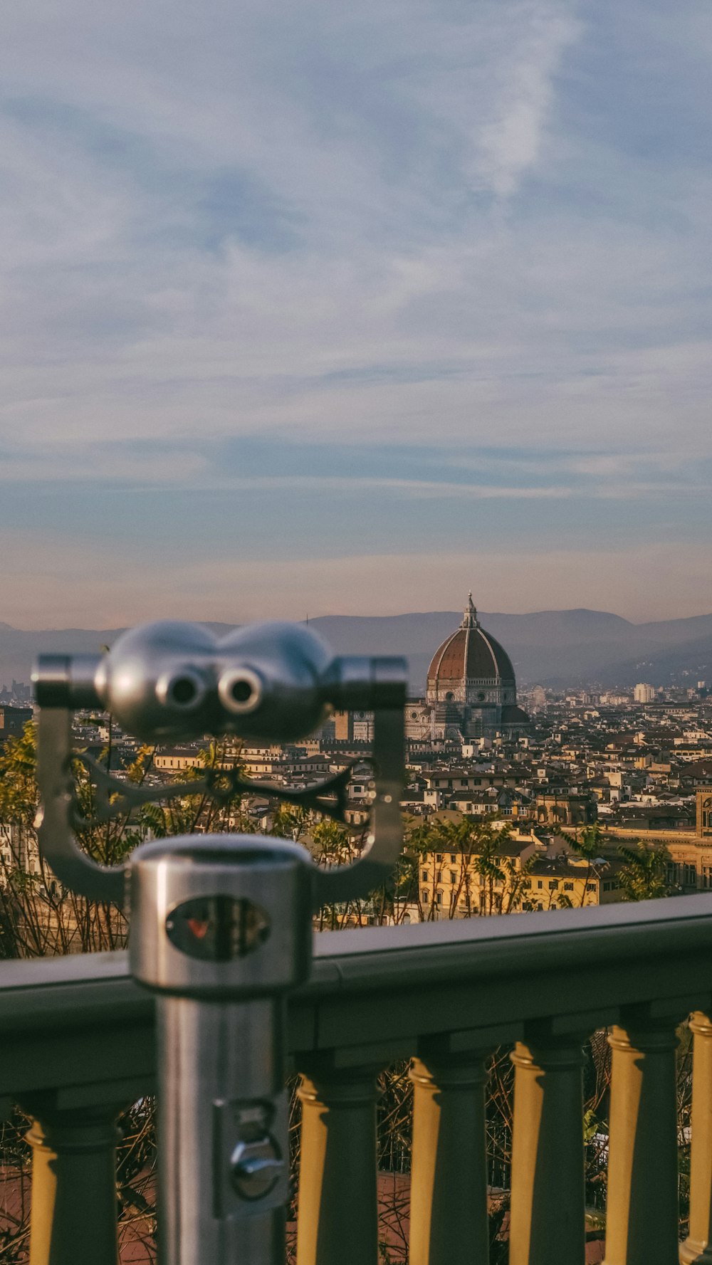 a metal object with a city in the background