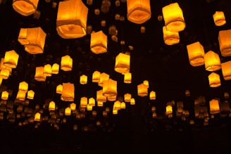 a group of lanterns floating in the air