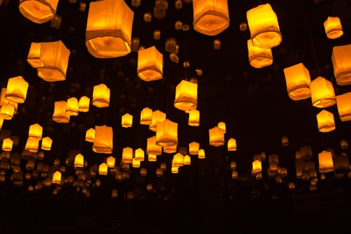a group of lanterns floating in the air