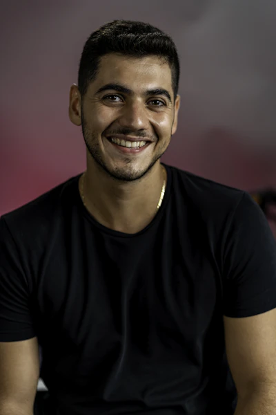 Portrait of Tommy, 26, a man in Matt's coaching cohort. Warm, approachable.