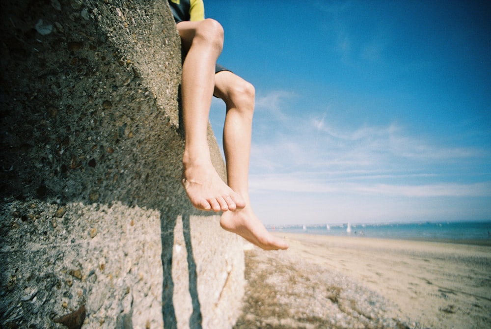 a person's legs on a rock