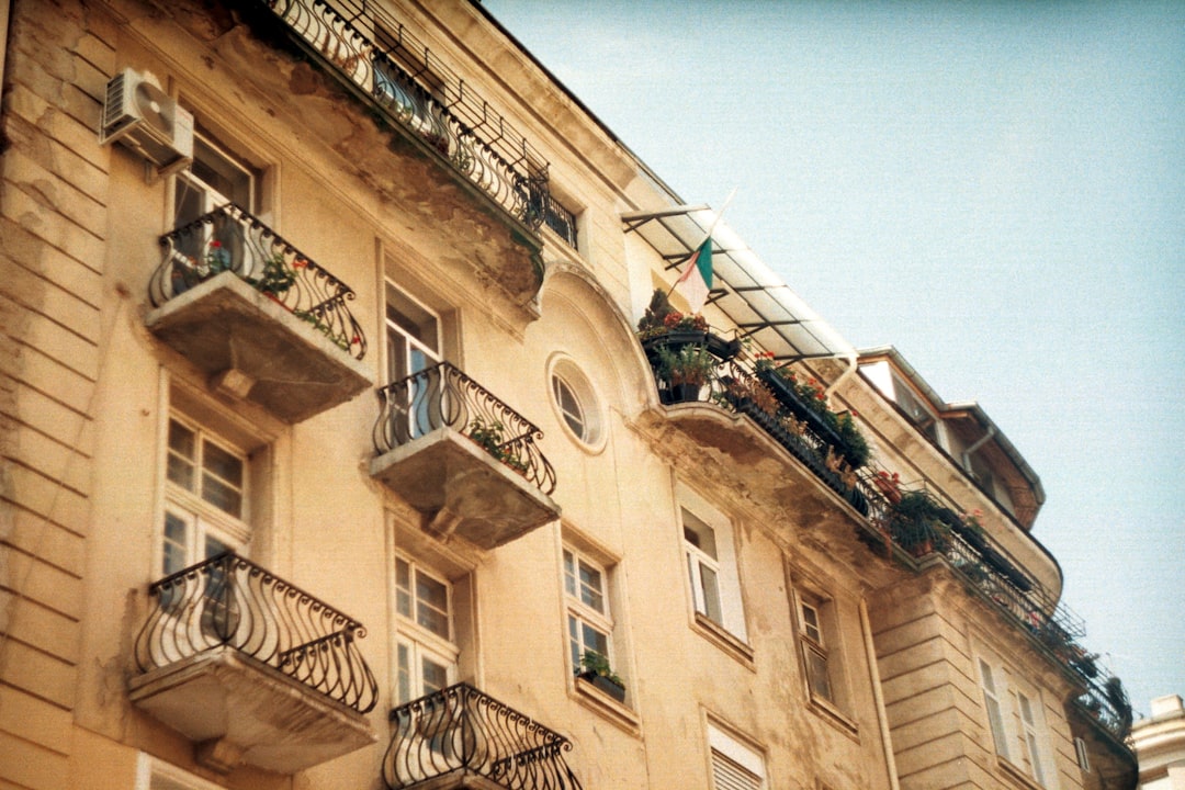 a building with balconies and balconies, Old yellow building