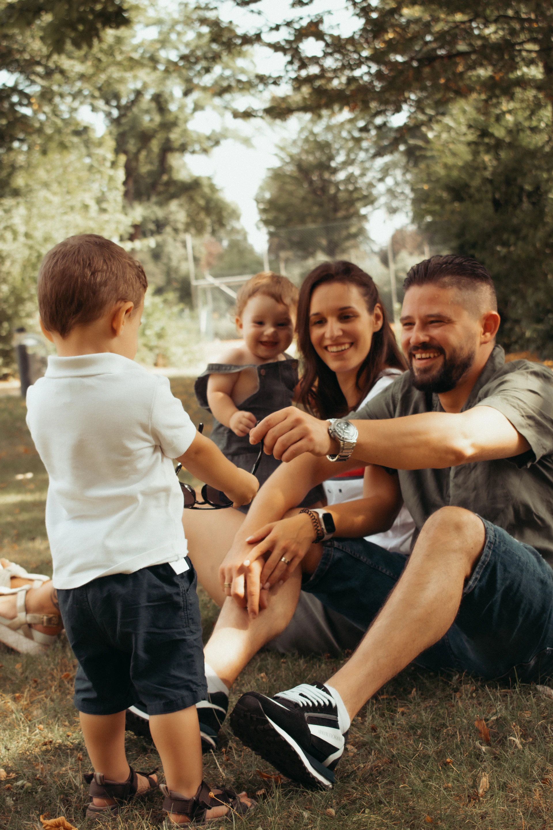 a family sitting on the grass