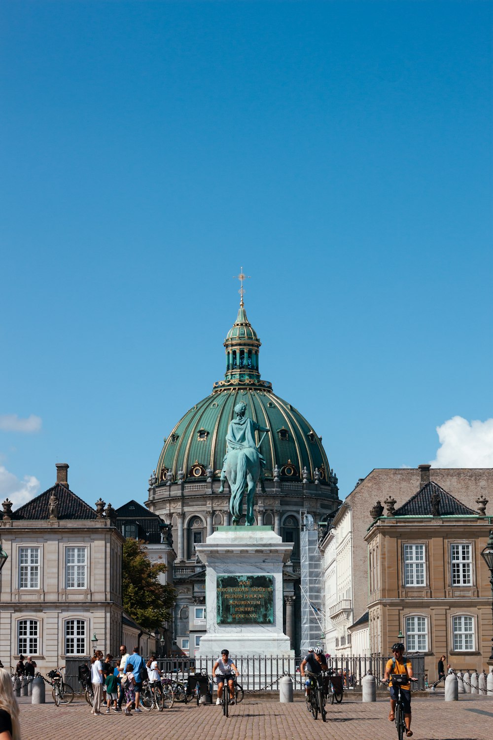 a statue of a person holding a torch in front of a building