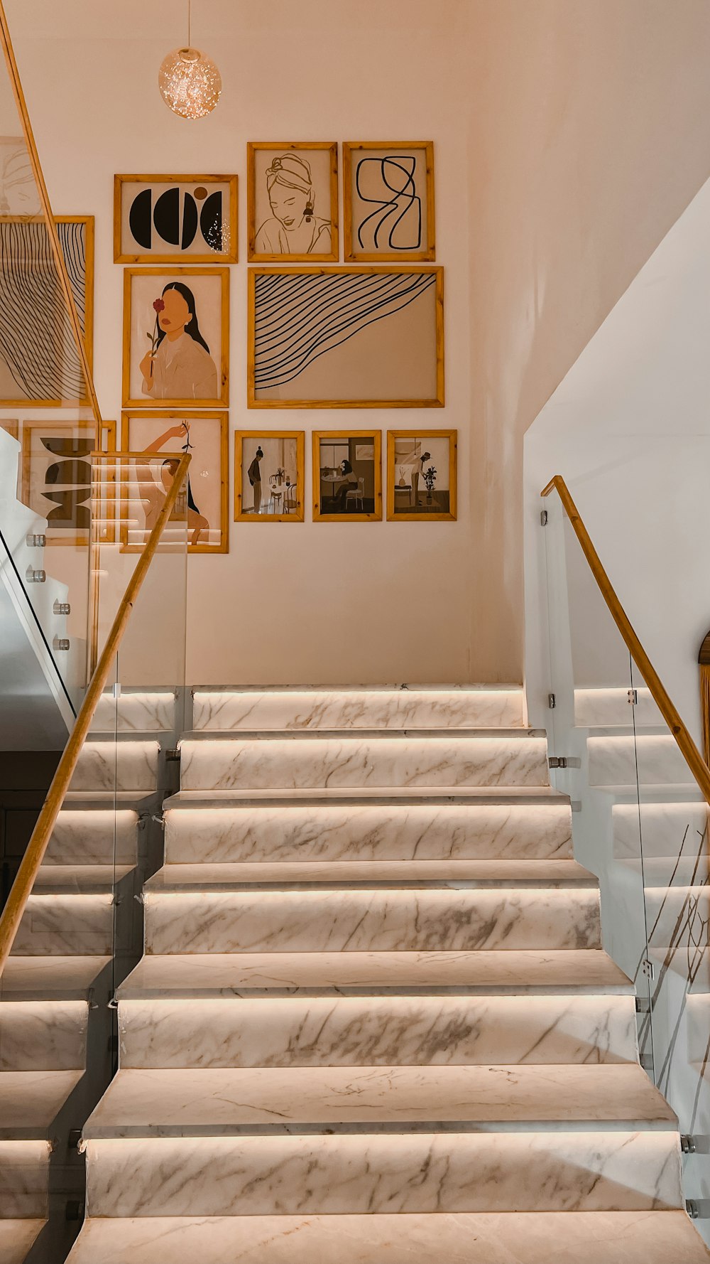 a staircase with a wall of paintings