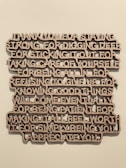 A piece of wall art with text expressing gratitude and appreciation, crafted in a three-dimensional style with brown letters casting shadows against a light wall.
