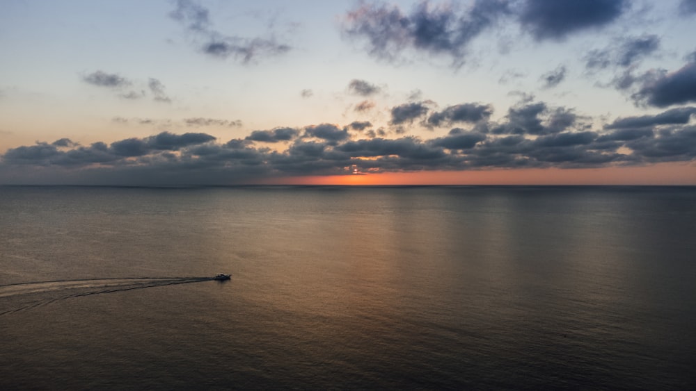 a body of water with a sunset