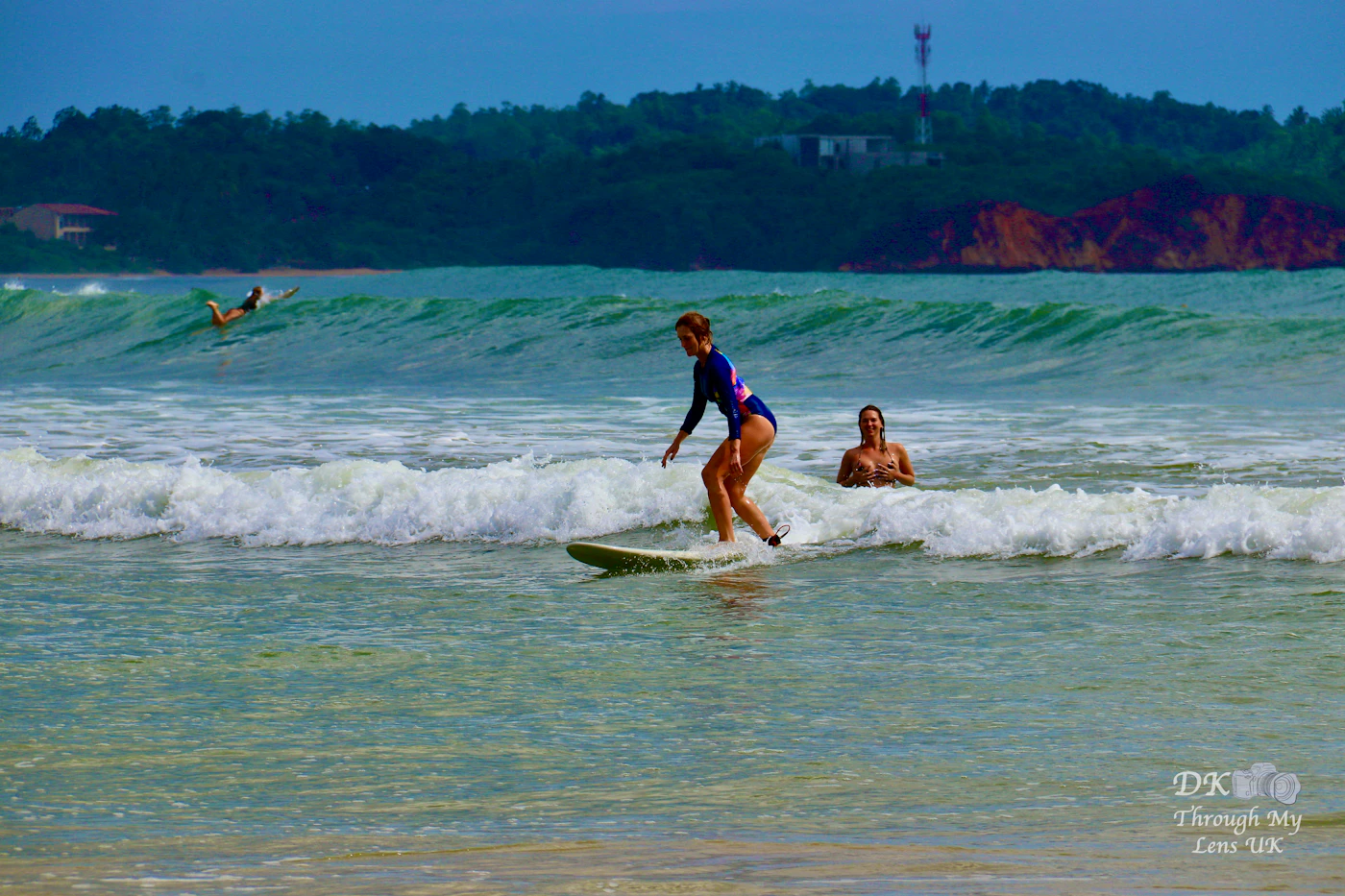 Beginner surfer riding a wave on the south coast of Sri Lanka