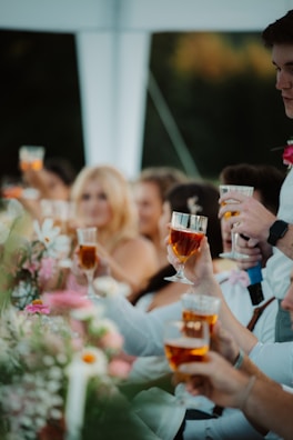 a group of people holding glasses of wine