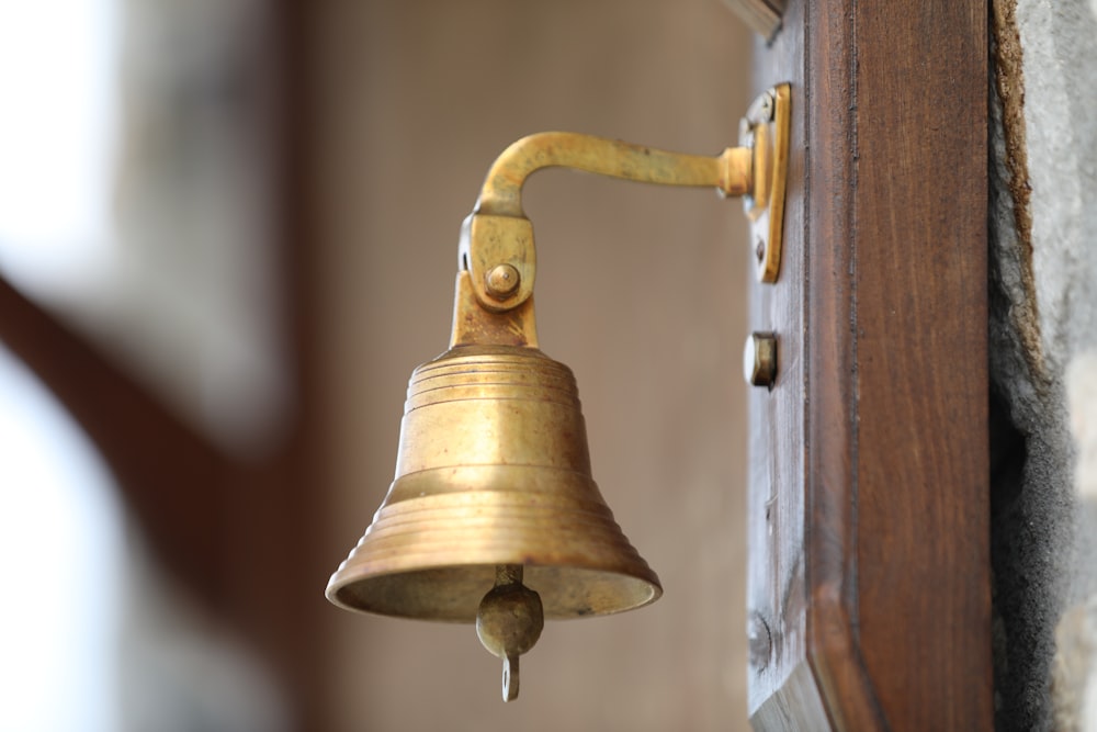 a brass bell on a wooden surface
