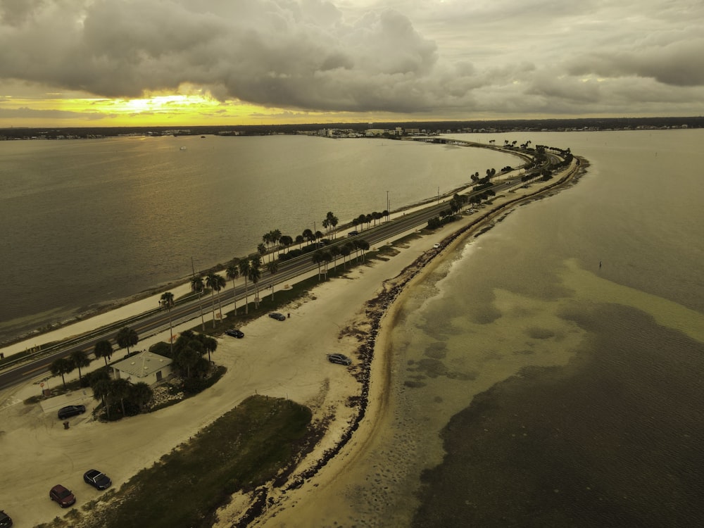 a beach with a body of water and a group of people