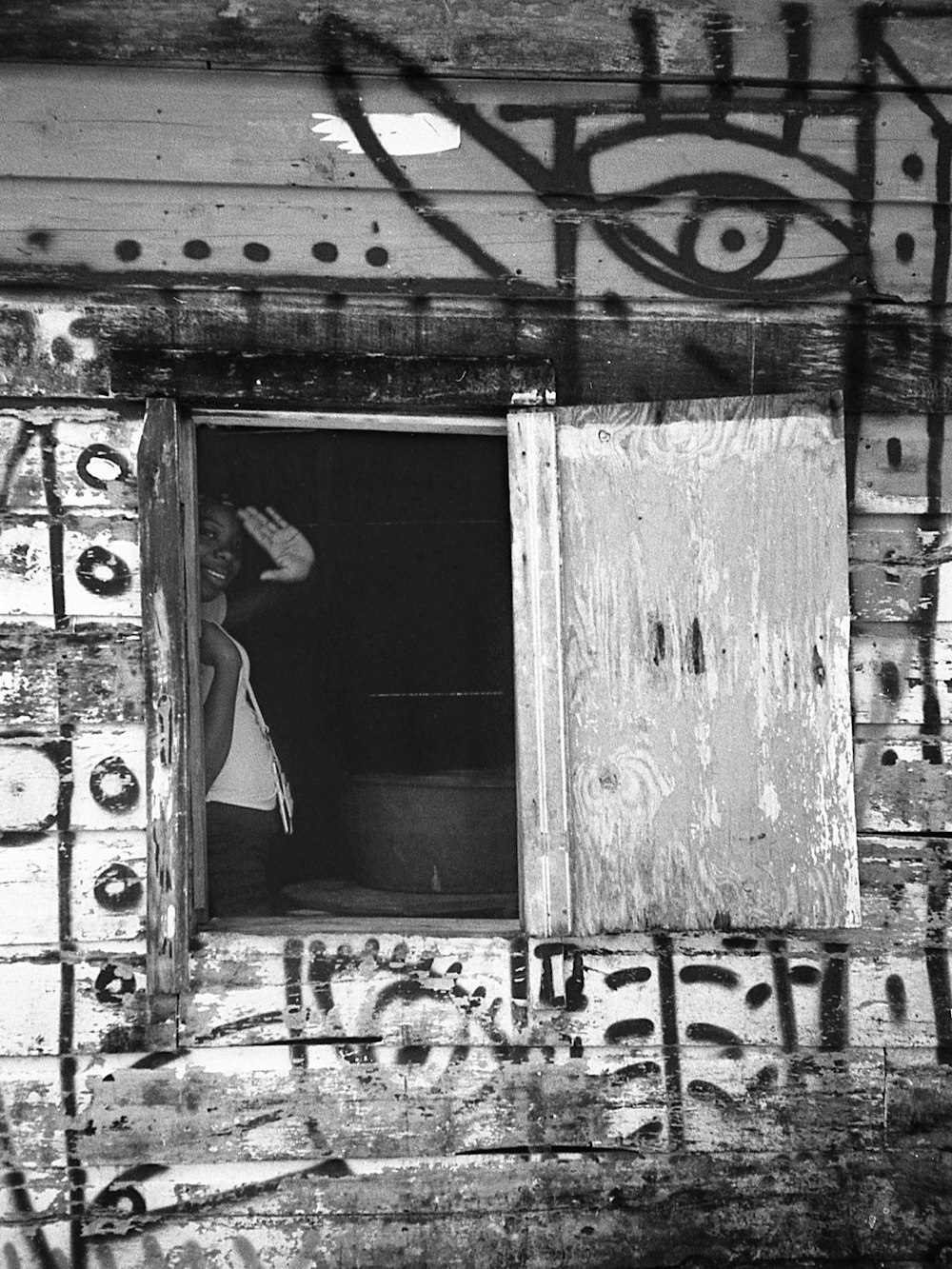 a person in a hat looking out a window