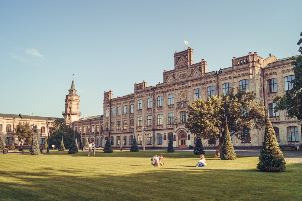 a large building with a lawn in front of it