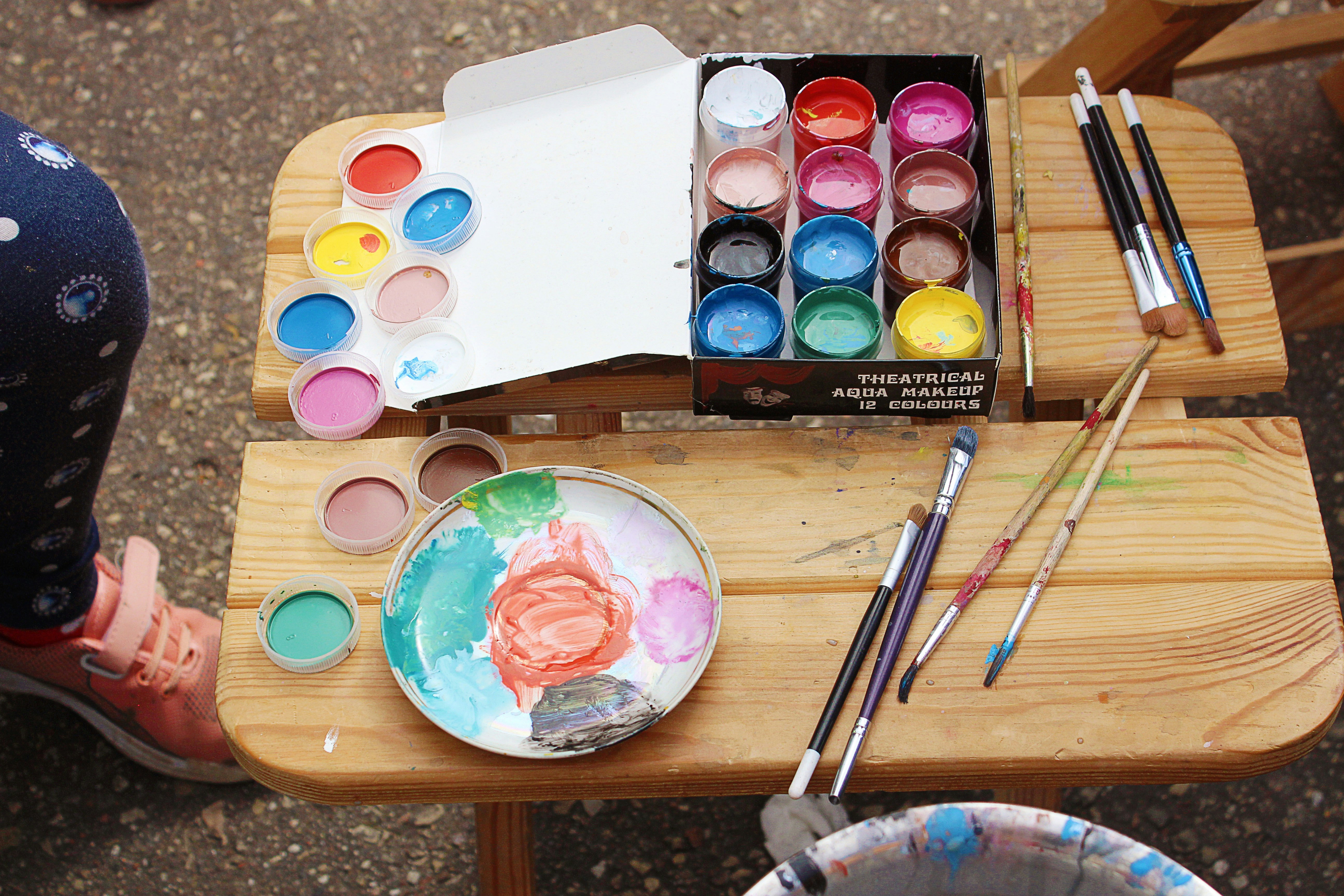 a table with paints and paint brushes