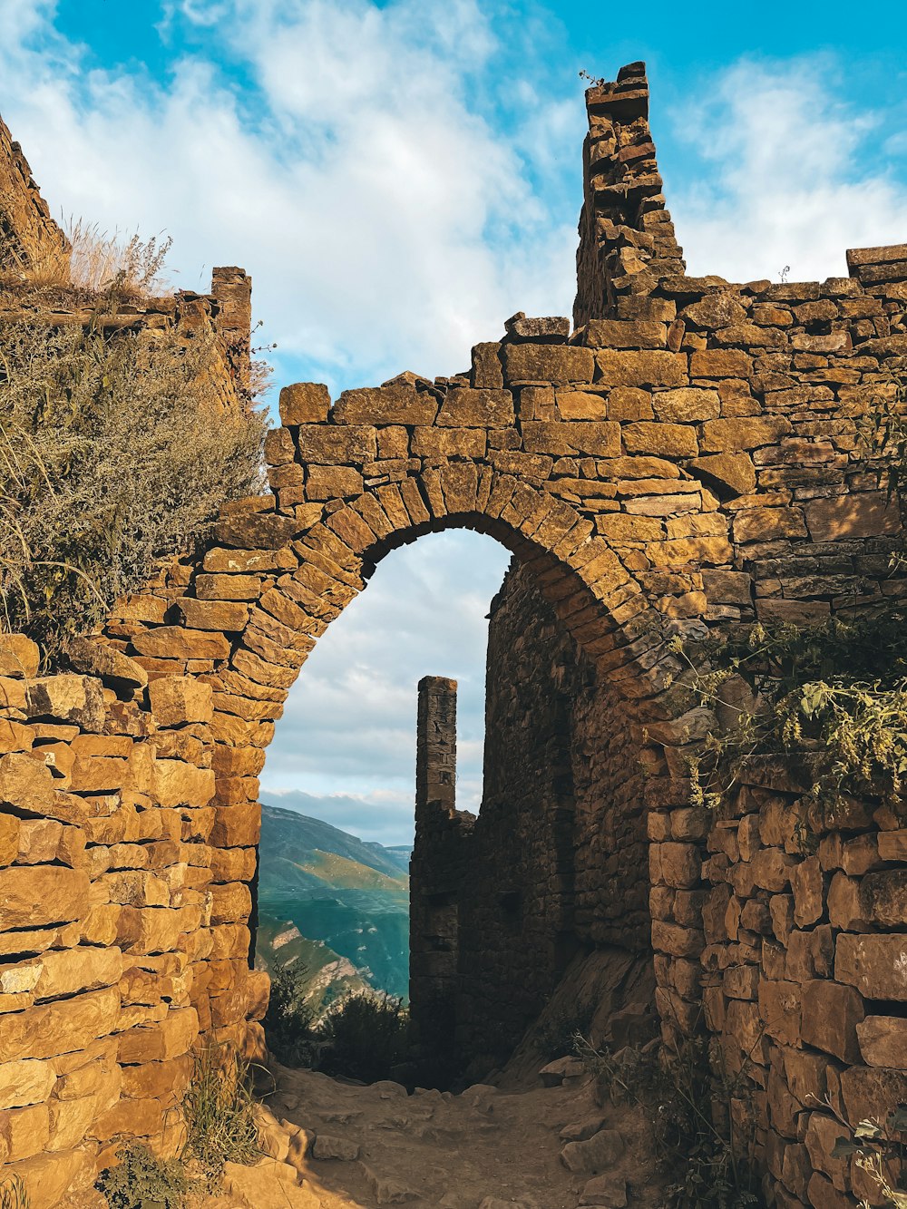 a stone archway with a tower