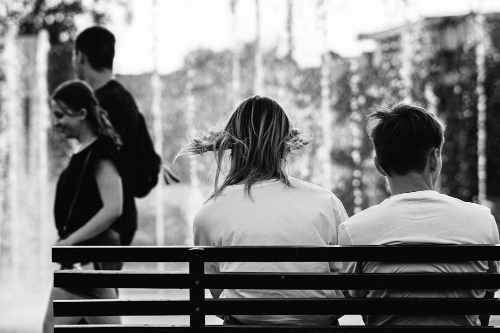 a group of people sitting on a bench