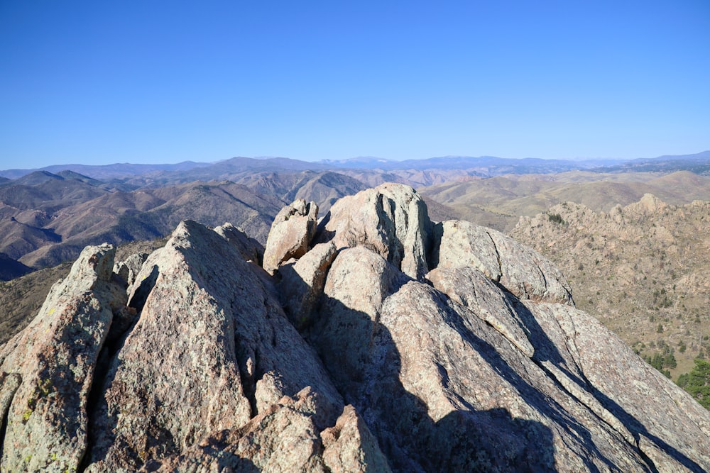 a rocky mountain with a valley below