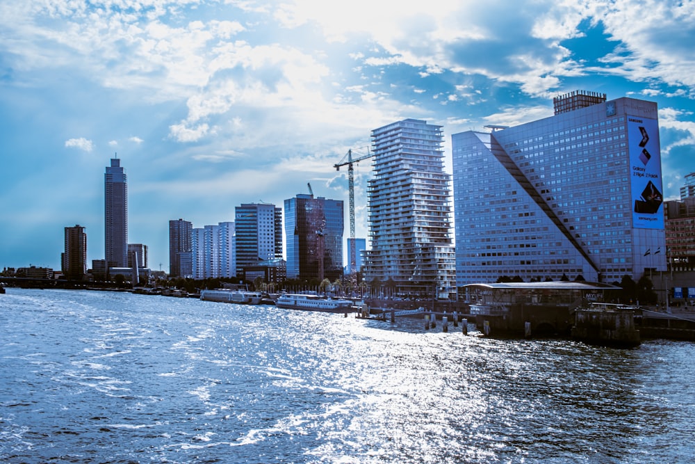 a city skyline with a body of water in front of it