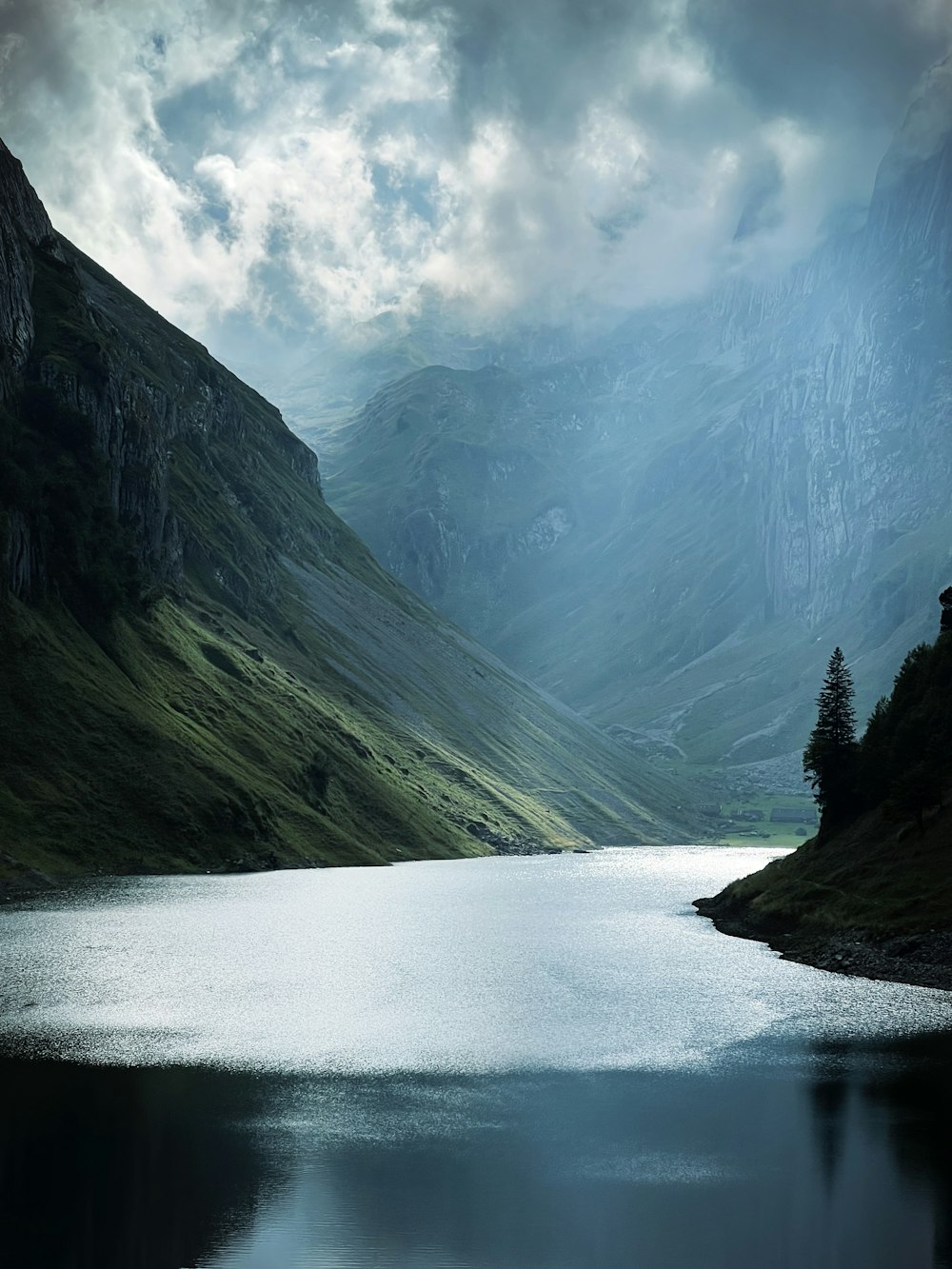 a body of water with mountains in the back