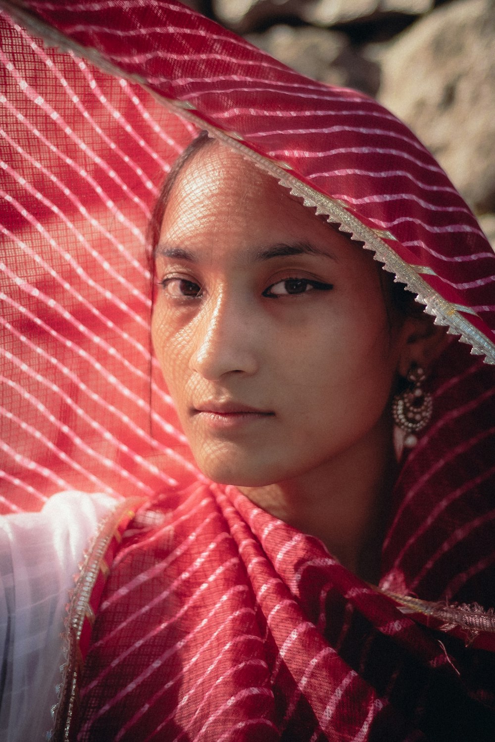 a man wearing a red and white head scarf