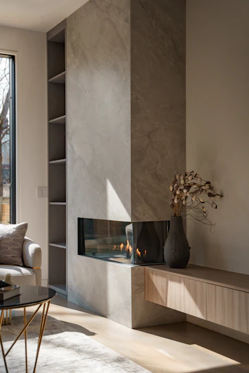 A sleek, modern gas fireplace installed in a cozy living room with neutral tones and minimalistic decor.