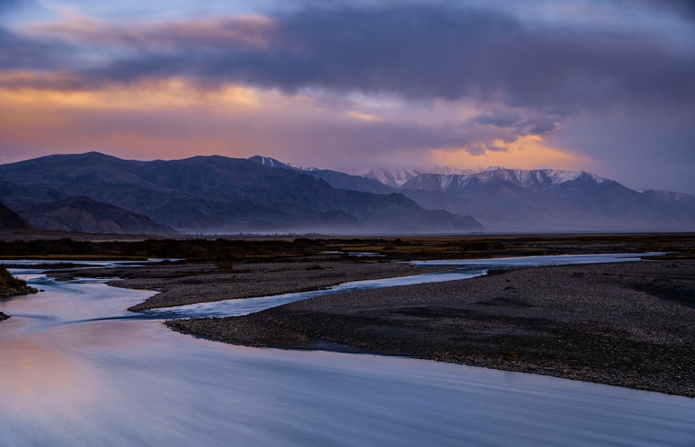 a river with a mountain in the background