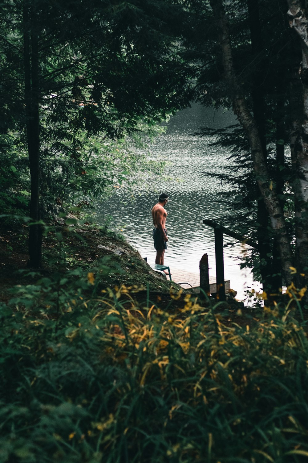 a man standing next to a tree