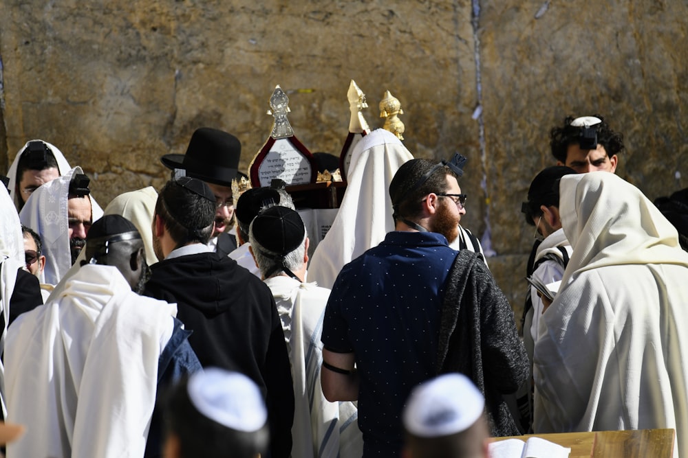 a group of people wearing white robes