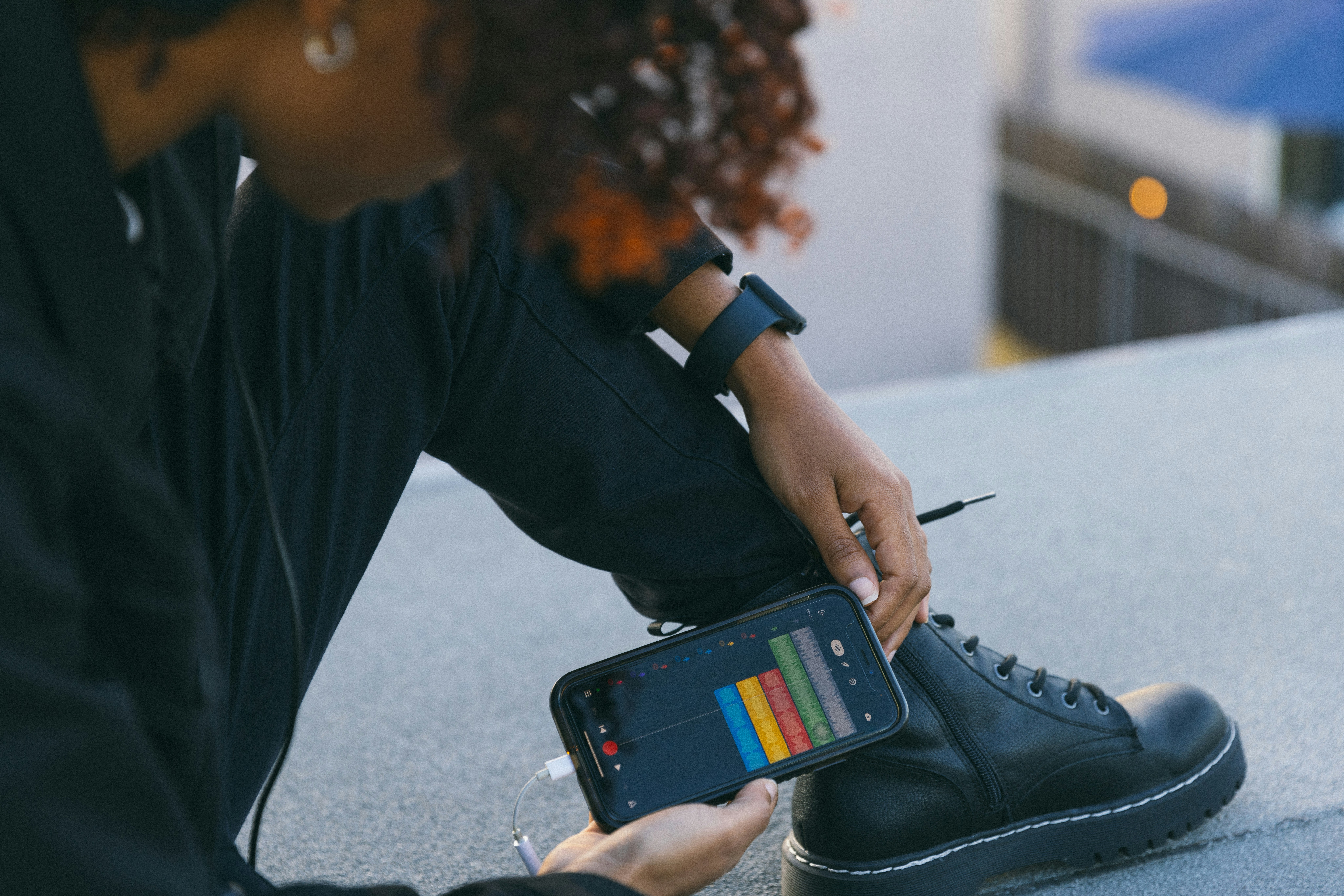 a man sitting on the ground with a cell phone