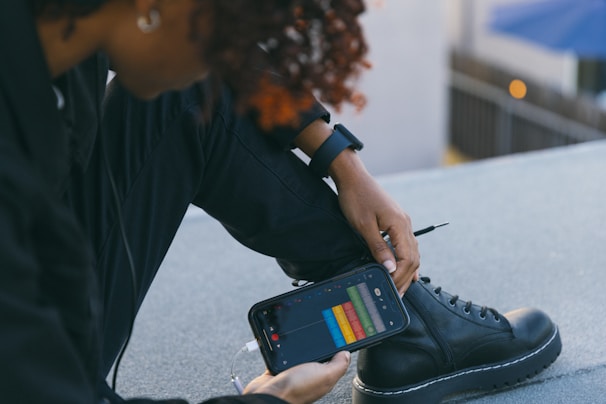 A user interacting with a smartphone app to customize audio settings.