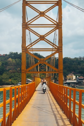 a person riding a bike on a bridge