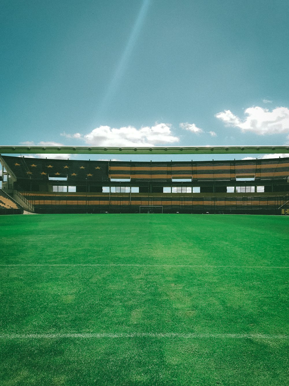 a green field with a building in the background