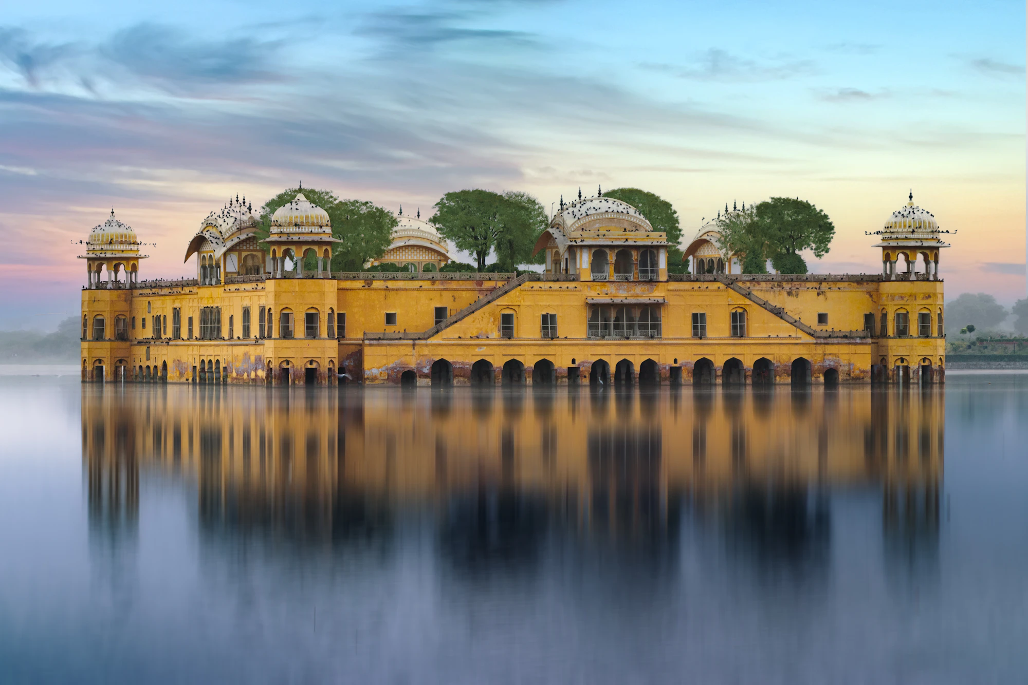 The Jal Mahal water palace reflected in a full Man Sagar Lake, Jaipur