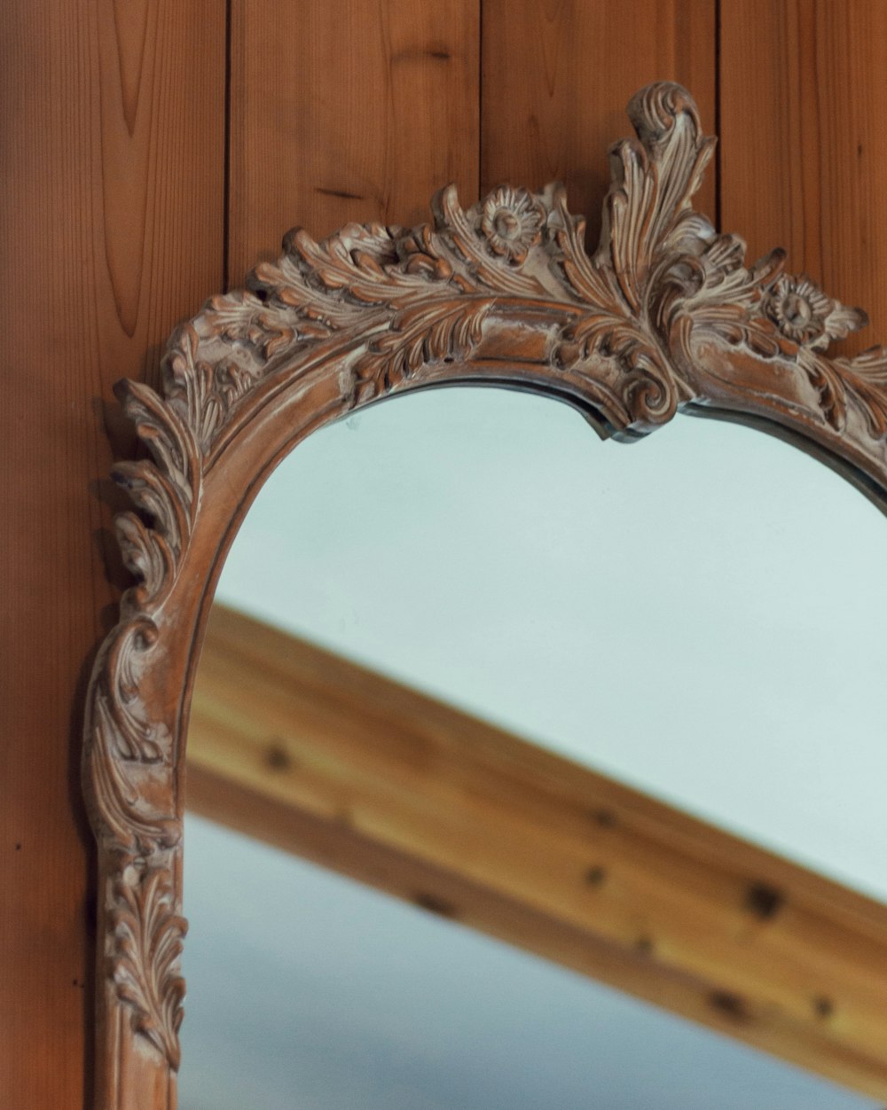 a wooden mirror with a handle