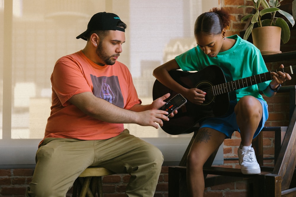 a man and a woman playing guitar