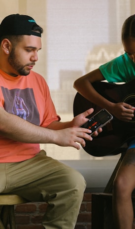 a man and a woman playing guitar