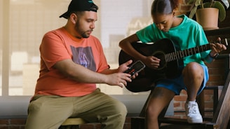 a man and a woman playing guitar