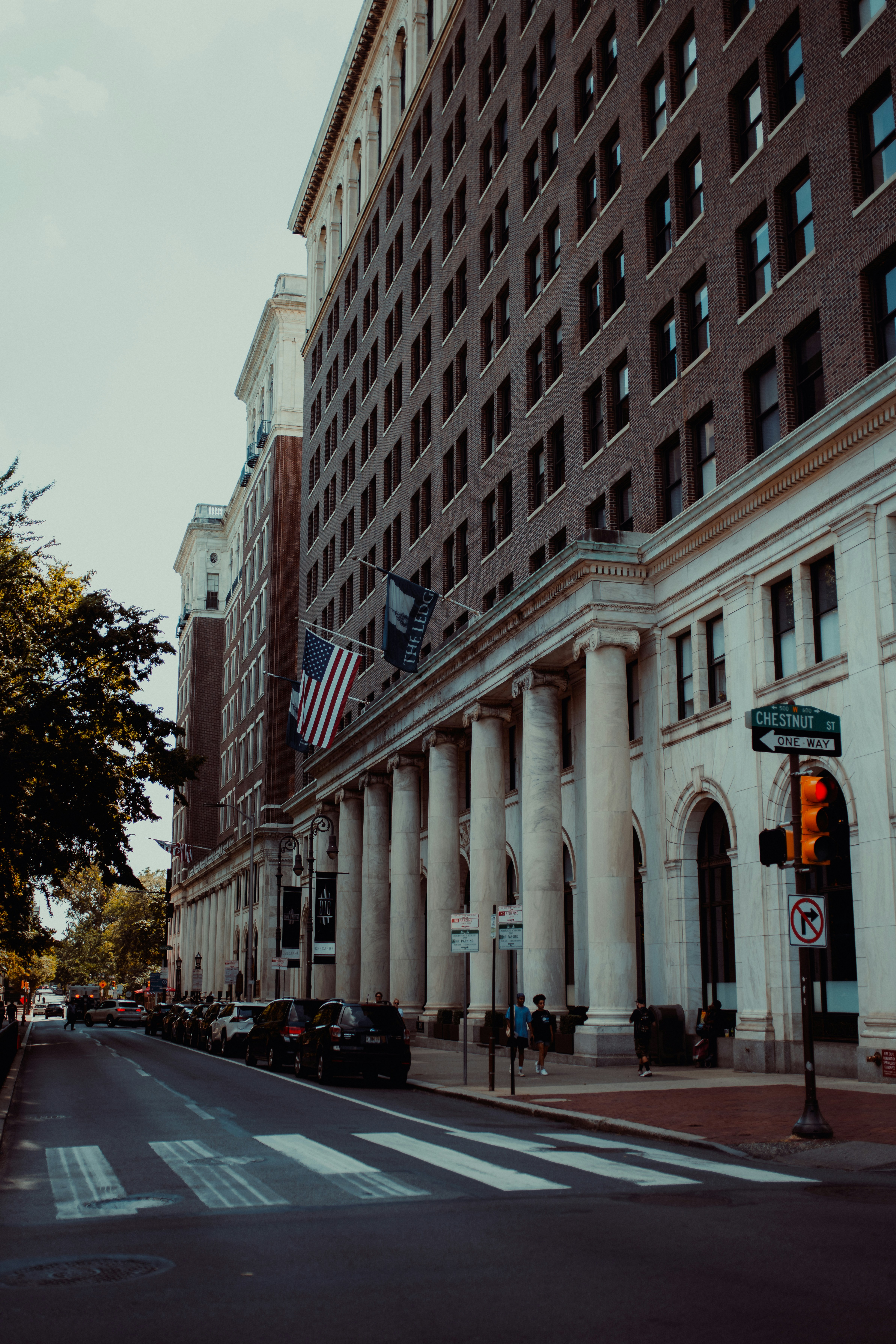 a large building with columns and a flag on top