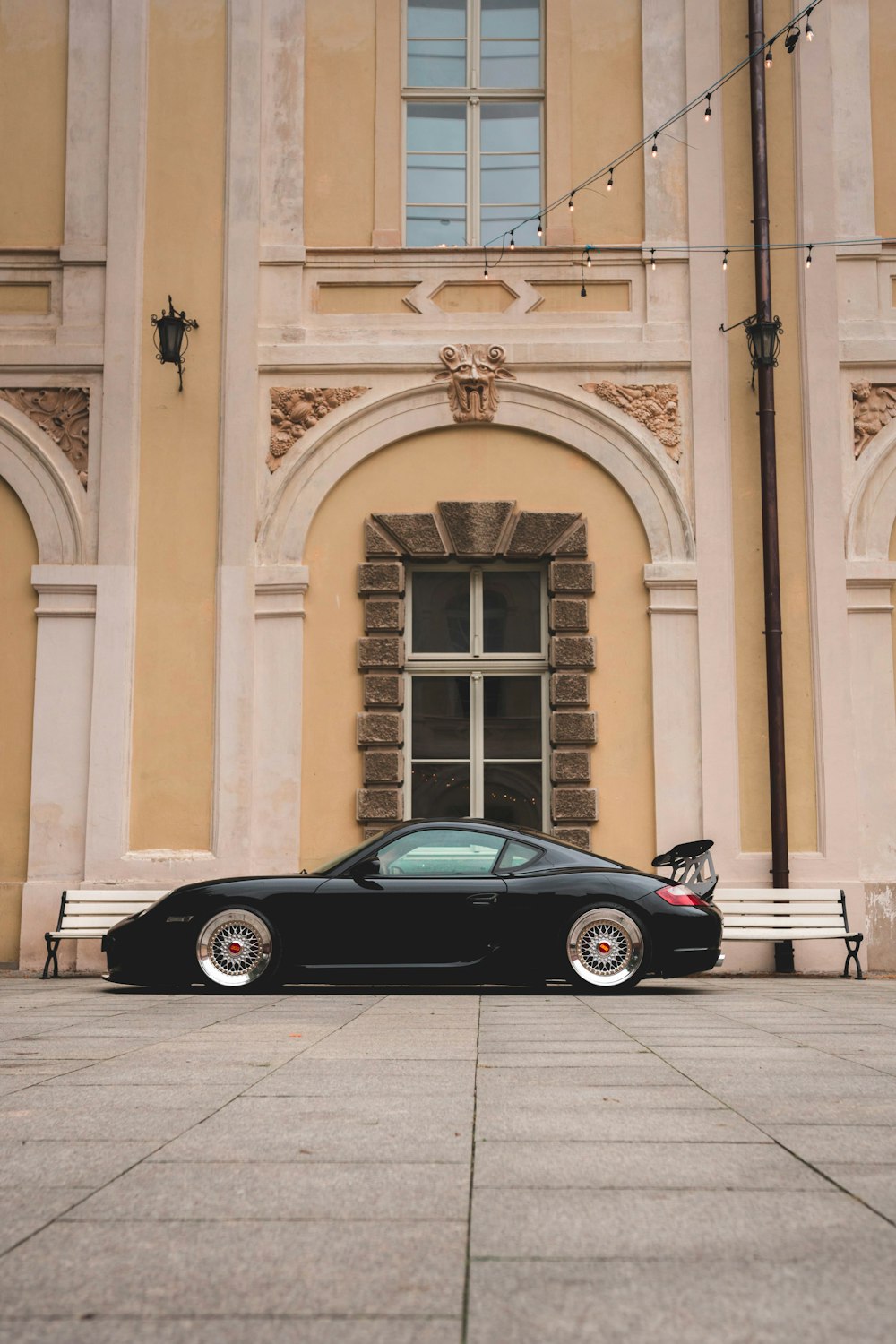 a black car parked in front of a building