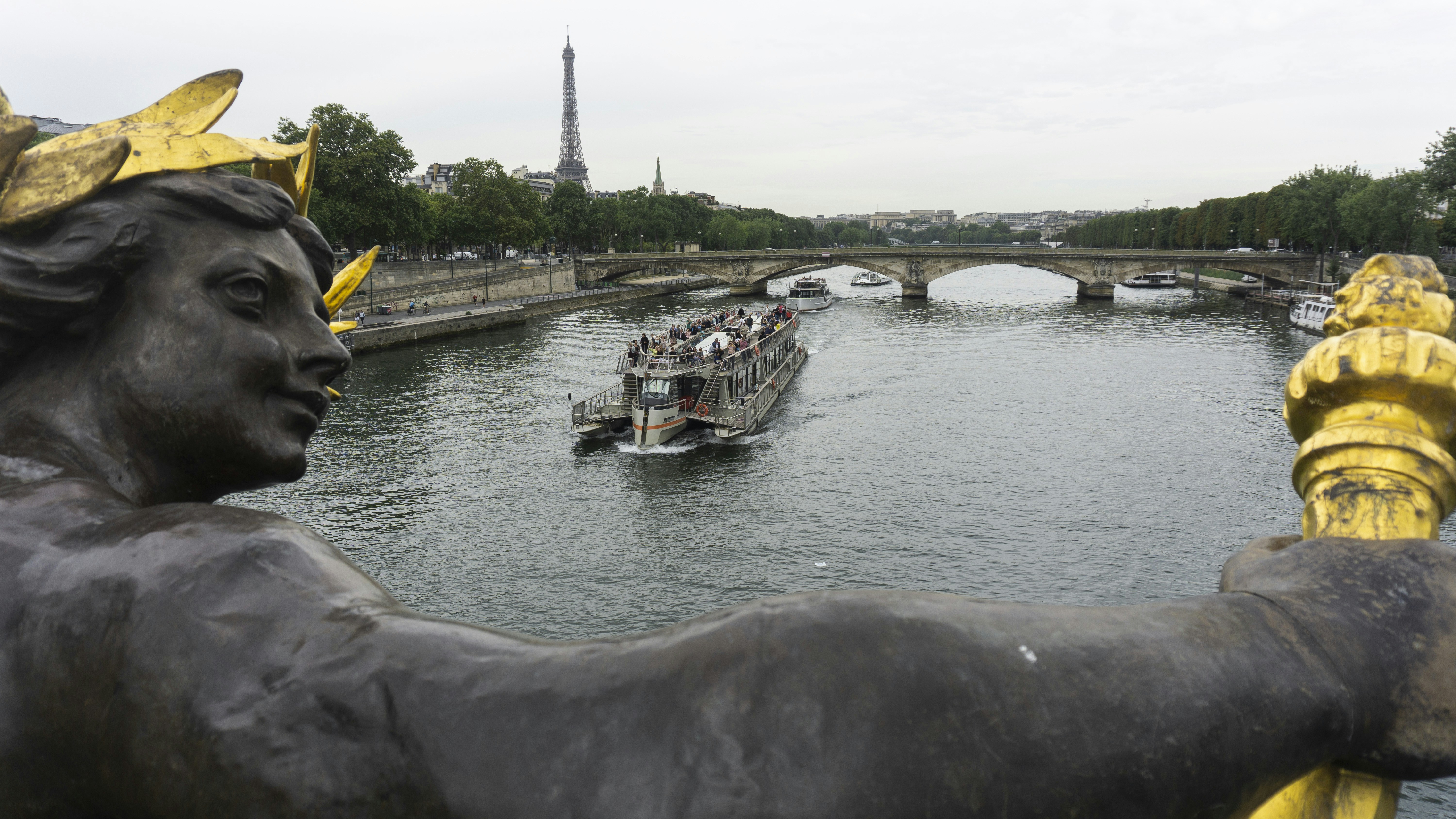 a statue of a man with a boat in the background, 