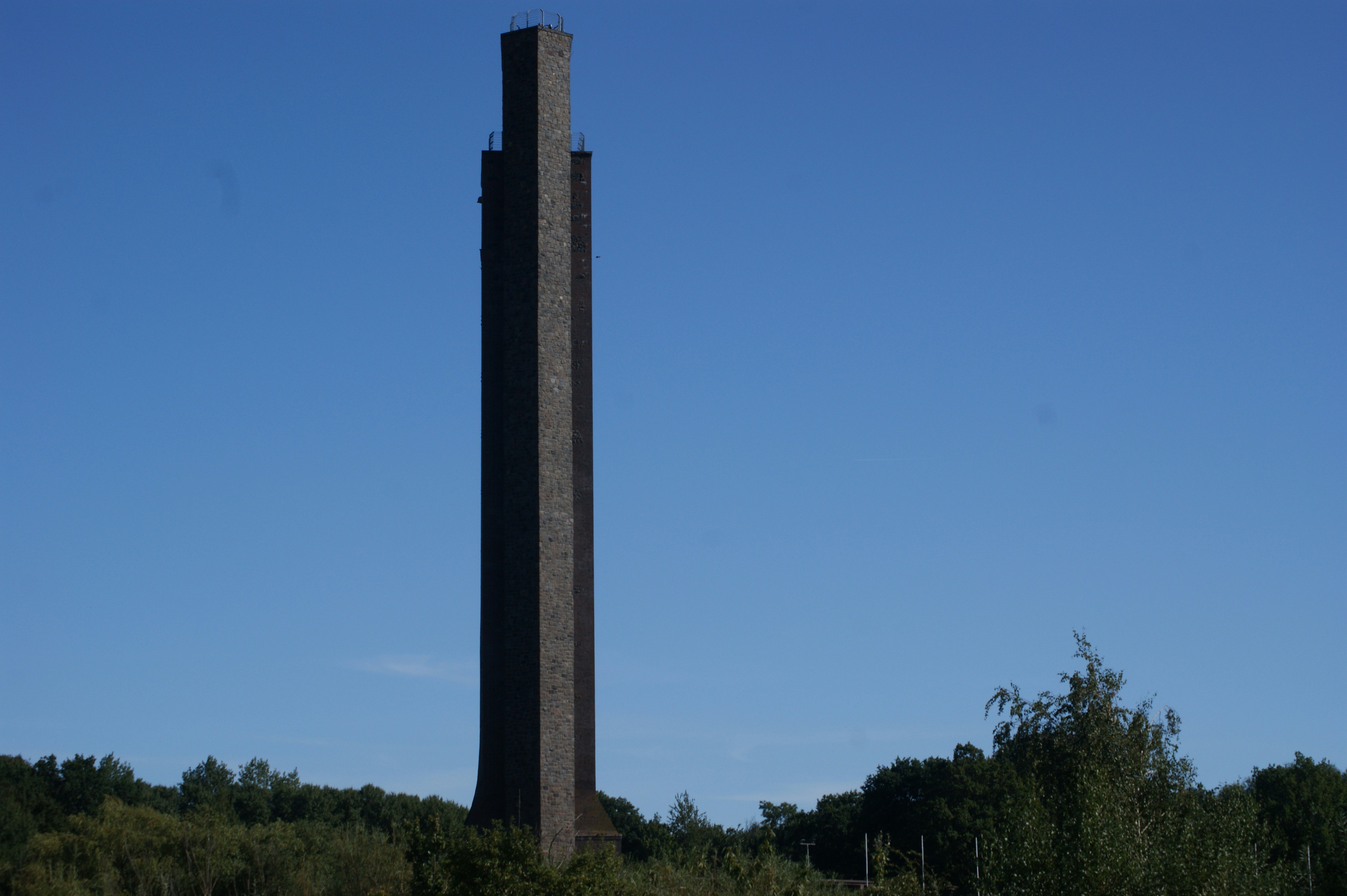a tall tower with trees around it