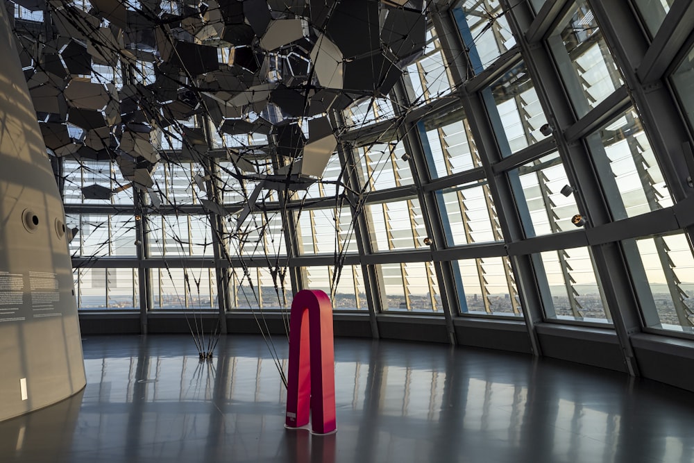 a red umbrella in a large room