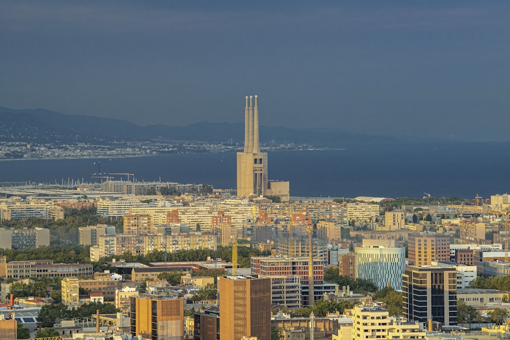 a city with a body of water in the background