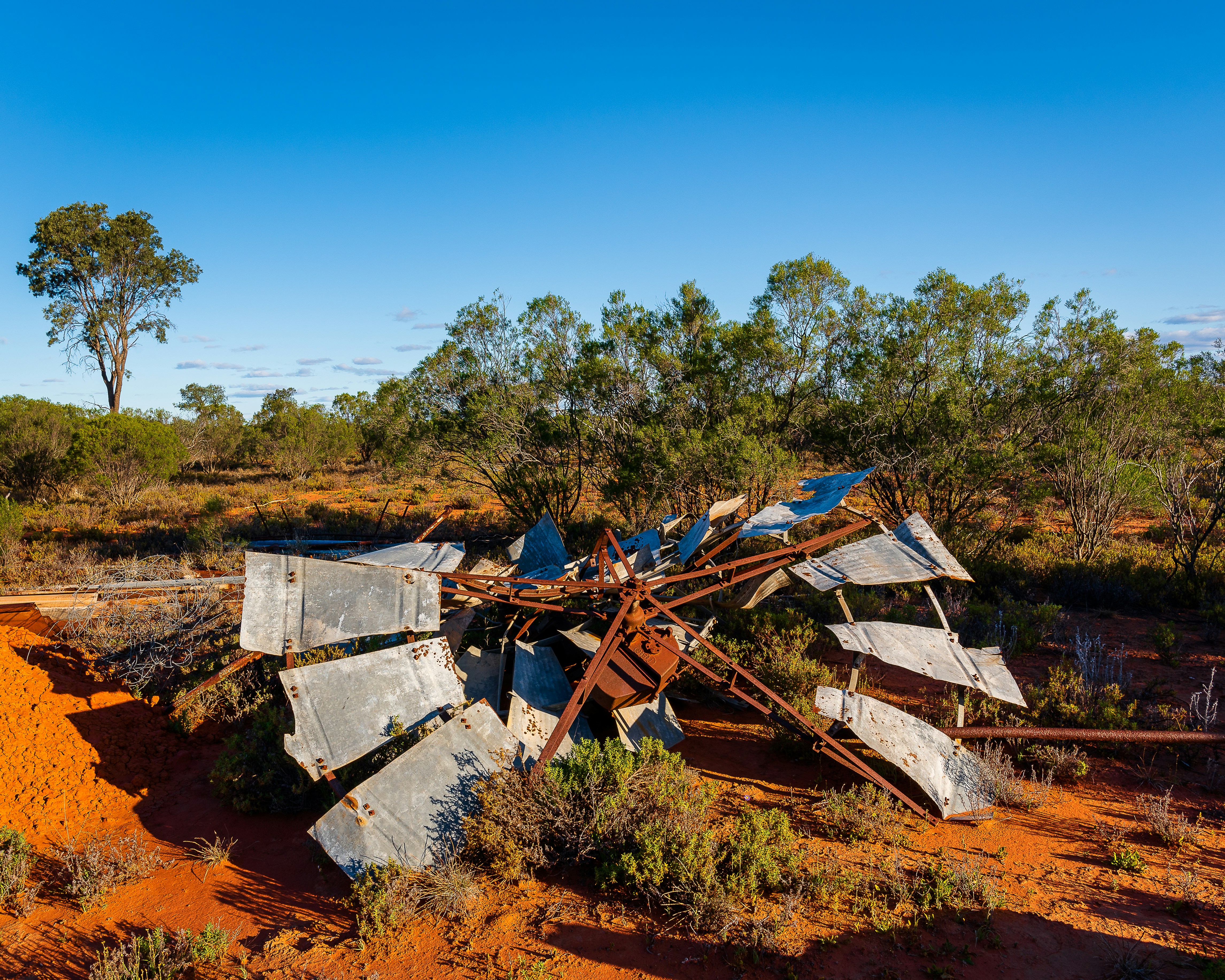 Remains of ruined windmill in the red dirt of outback Australia