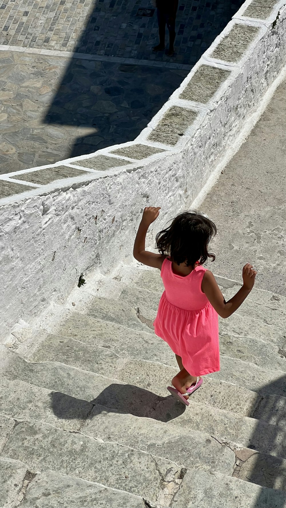 a girl standing on a stone walkway